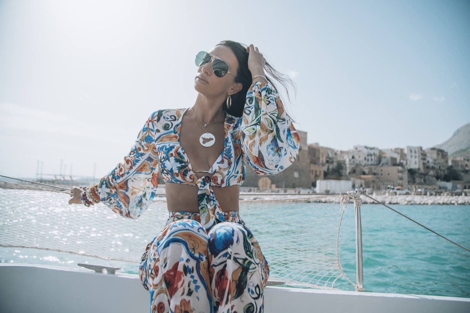 Oriana Lamarca on a boat off the Sicilian coast, wearing handcrafted gemstone bracelets