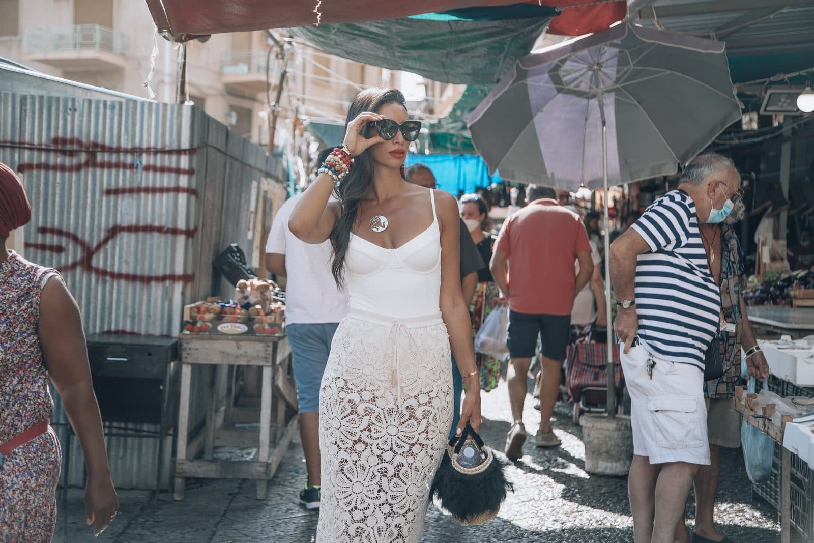 Oriana walking through a Palermo street market